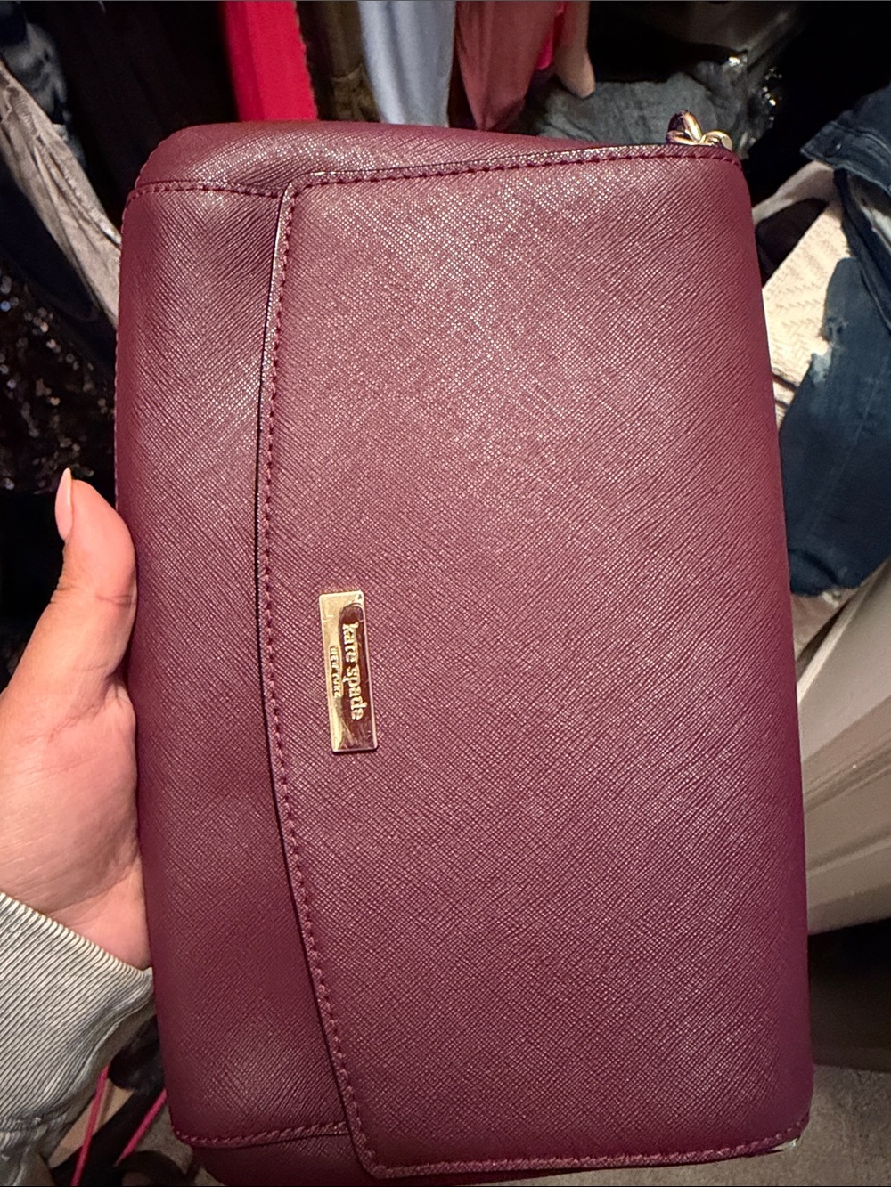 kate spade plum-textured leather wristlet with gold logo